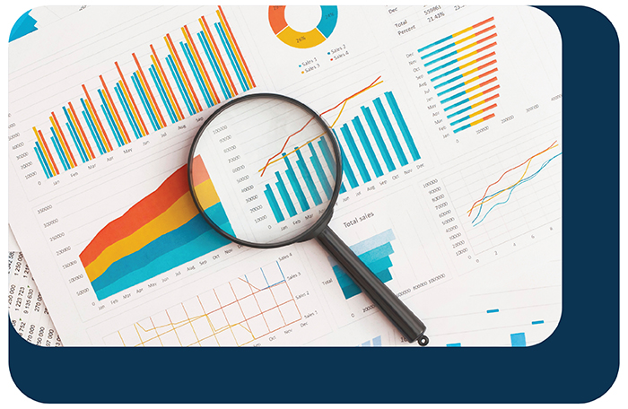 Magnifying glass over charts and reports